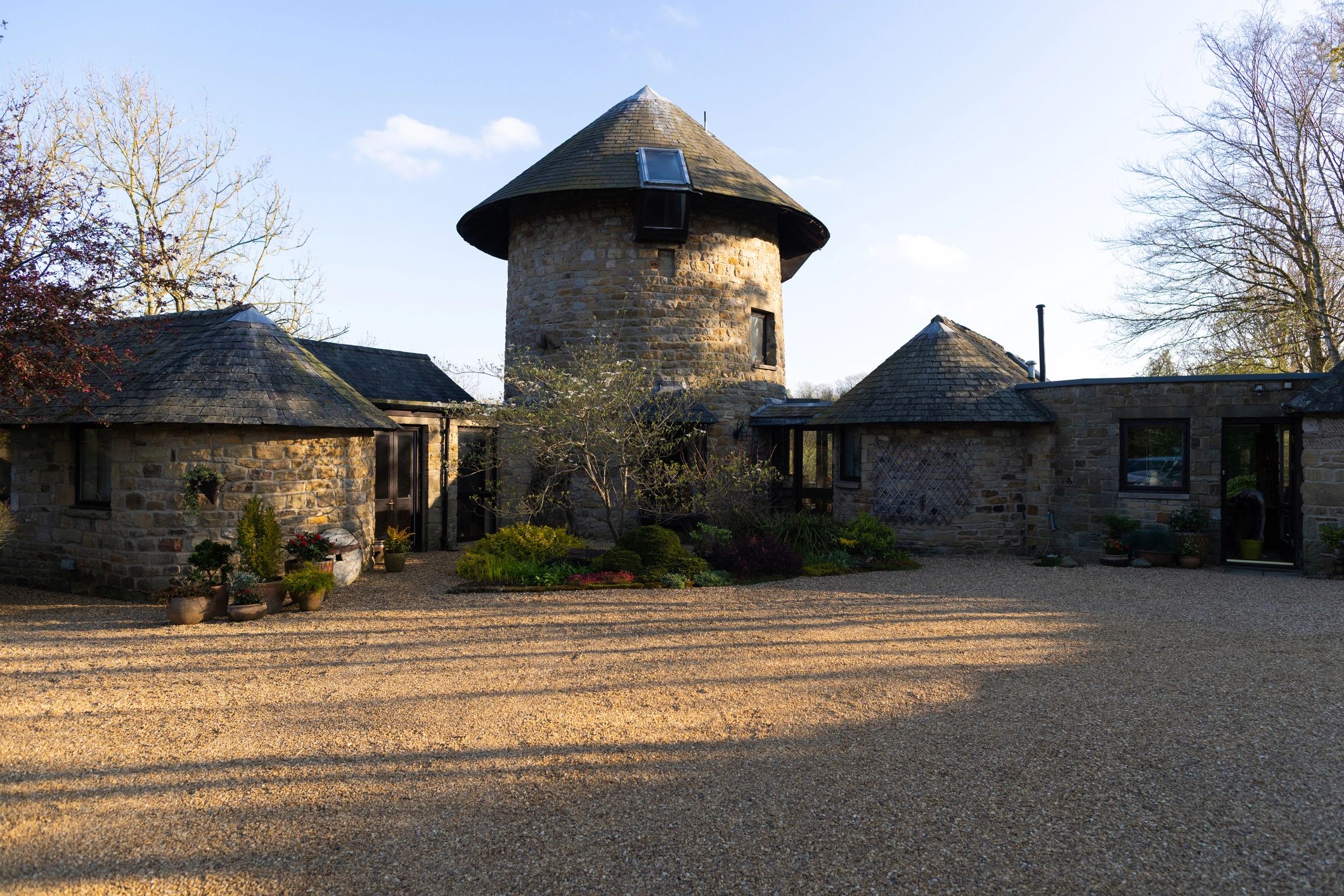 Traditional stone home exterior with garden landscaping